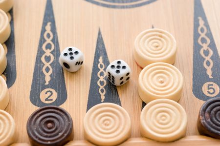 On the game board game backgammon chips and dice 5-5の写真素材