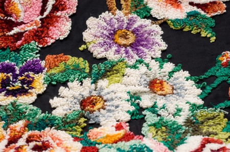 Fragment of emroidery needles on a black-colored fabrics. Ukraine, the middle of the 20th century. Handmade, family relic.の写真素材