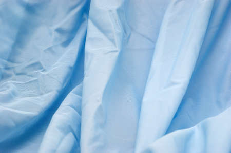 The background of textured blue synthetic fabric closeupの写真素材