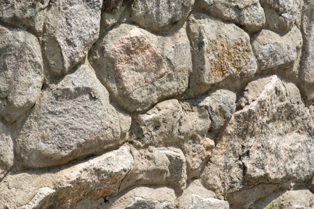 The background of textured of facade stone wall closeup