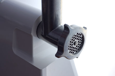  Electric meat grinder on a white background closeup