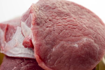 Pieces of fresh beef on a white background closeupの写真素材