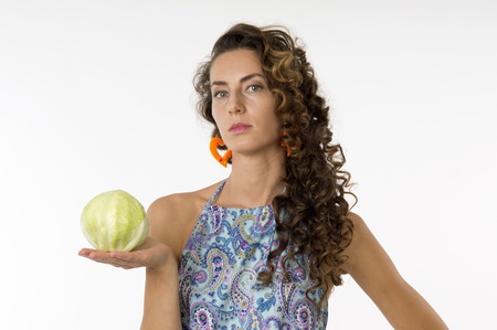 Portrait of a young beautiful woman in a blue dress with an cabbage in his handの写真素材