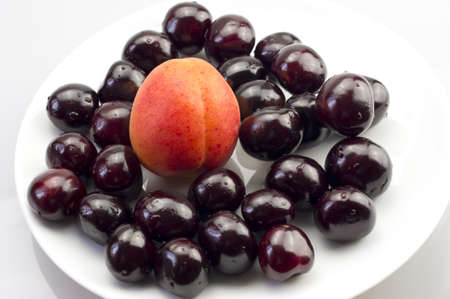 Apricot and cherries on a plate closeupの写真素材