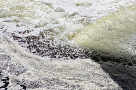 Discharge of industrial effluents into the River, the foam on the water