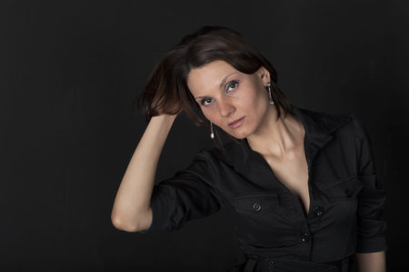 Portrait of a young pretty woman in a black dressの写真素材