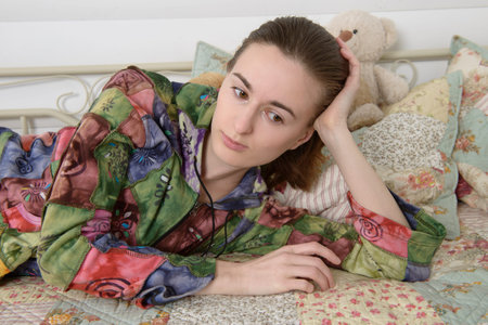 Young woman in the children's room on the bed