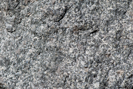 Background of walls, built of grey granite stones close up