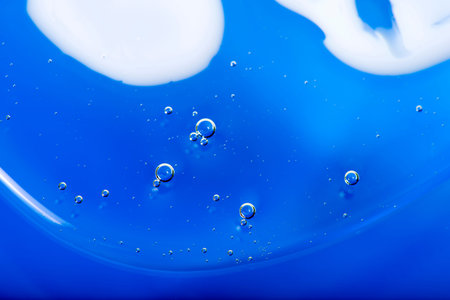 Abstract blue background from the liquid with air bubbles closeup