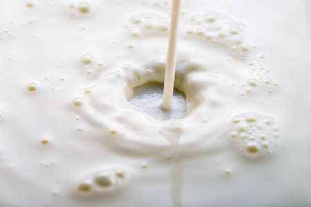  Background of fresh milk, which is poured into a saucerの写真素材