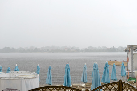 Free beach sun beds at the resort on a rainy summer dayの写真素材