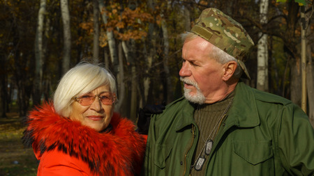 Portrait of a loving elderly couple in the background of the autumn city parkの写真素材