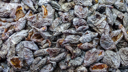 Dried plum in sugar without pits closeup backgroundの写真素材