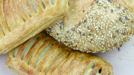 Still life of bread baking and sweet buns, food background closeup
