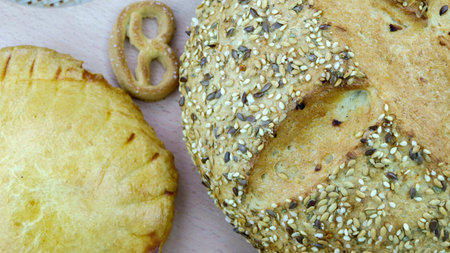 Still life of bread baking and sweet buns, food background closeup