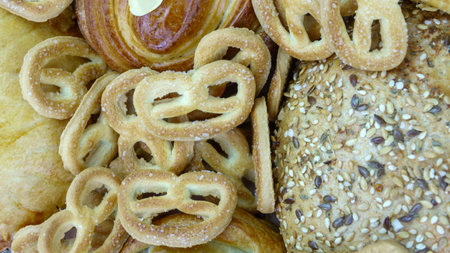 Still life of bread baking and sweet buns, food background closeup