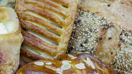 Still life of bread baking and sweet buns, food background closeup