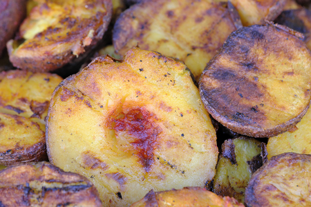 Grilled potatoes outdoors on a bright sunny spring day at a picnicの写真素材