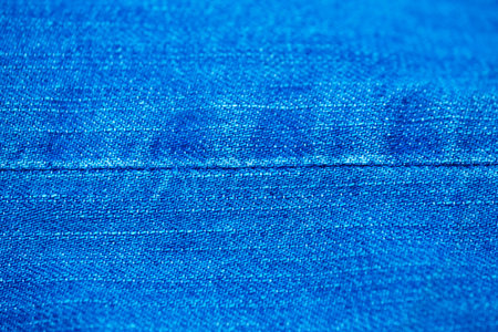 Blue denim background shot with shallow depth of field close-up macro