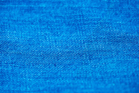 Blue denim background shot with shallow depth of field close-up macro