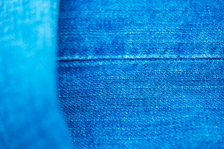 Blue denim background shot with shallow depth of field close-up macroの写真素材