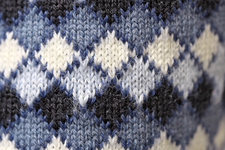 Knitted wool machine knitted fabric close-up, sweater element macro photo colored backgroundの写真素材