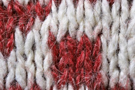 Knitted woolen fabric of a machine large knitting close-up, an element of a men's sweater macro photo colored backgroundの写真素材