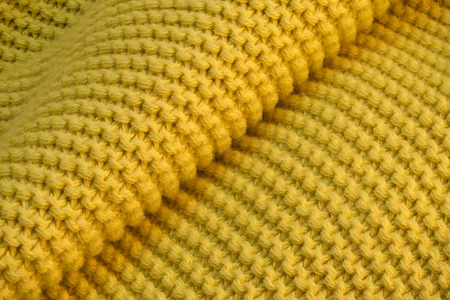 Yellow knitted wool fabric with large loops backgroundの写真素材