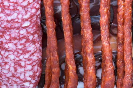 Meat food background from assorted dried sausages of different varieties illustration of meat...