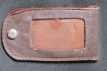 Textured leather background from fragments of an old shabby used navigator's briefcase close-up macro photographyの写真素材