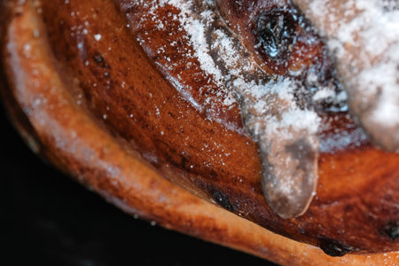 Cherry pie with chocolate icing sprinkled with powdered sugar close-up macro photographyの写真素材