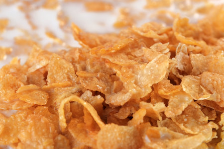 Cornflakes with sugar icing with milk for breakfast close-up macro photography
