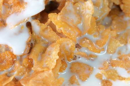 Cornflakes with sugar icing with milk for breakfast close-up macro photography
