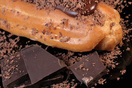 Custard cake sprinkled with dark chocolate shavings close-up macro photography