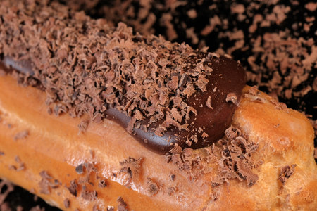 Custard cake sprinkled with dark chocolate shavings close-up macro photography