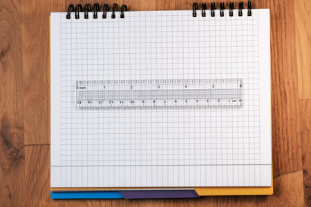 Stationery composition with colored pencils on a notebook with checkered sheets close-upの写真素材