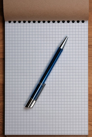 Stationery composition with colored pencils on a notebook with checkered sheets close-upの写真素材