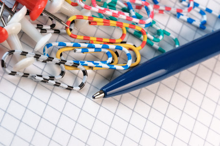 Minimalistic composition on a green background with stationery bindings close-up macro photography
