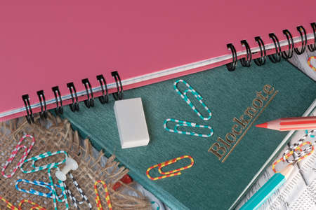 Layout composition with loose-leaf notebook on white wooden background with candleの写真素材