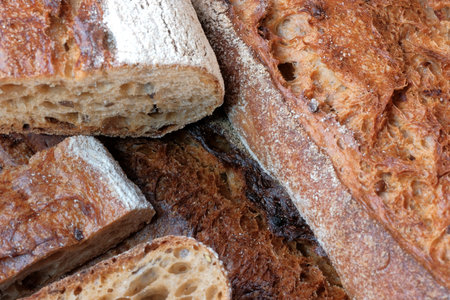 Hearth whole grain bread baguette with the addition of buckwheat flour close-up macro photography