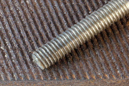 Art picture with rusty iron old bolt and nut on the surface of a used file close-up macro...