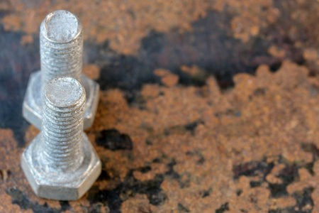 Art picture with rusty iron old bolt and nut on the surface of a used file close-up macro...