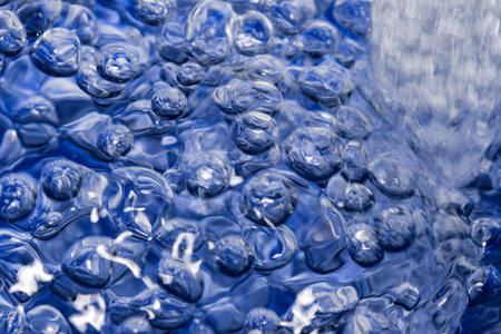 Abstract artistic textured pink background with air bubbles on water surface close-up