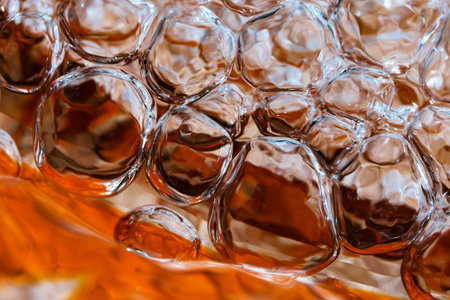 Abstract macro photography water in a powerful stream fills a red vase with the formation of air...