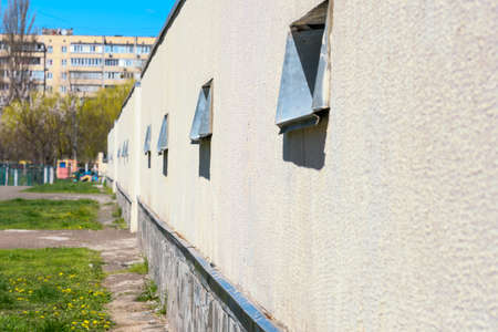 Fragment of an urban multi-apartment high-rise residential building against the background of a blue spring sky, real estate objectの写真素材