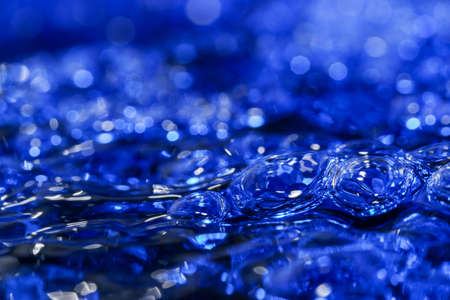Abstract texture art blue water background with air bubbles close-up macro photographyの写真素材
