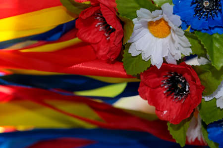 Artificial flowers and ribbons of the Slavic Ukrainian wreath for girls close-up macro photographyの写真素材
