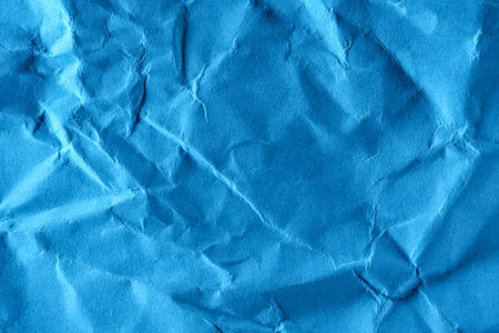 Paper textured background from crumpled blue paper close-up macro photography high detail