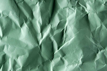 Paper textured background from crumpled green paper close-up macro photography high detailの写真素材