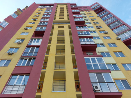 Facade of a residential modern high-rise urban house with beautiful colors on a bright summer sunny...